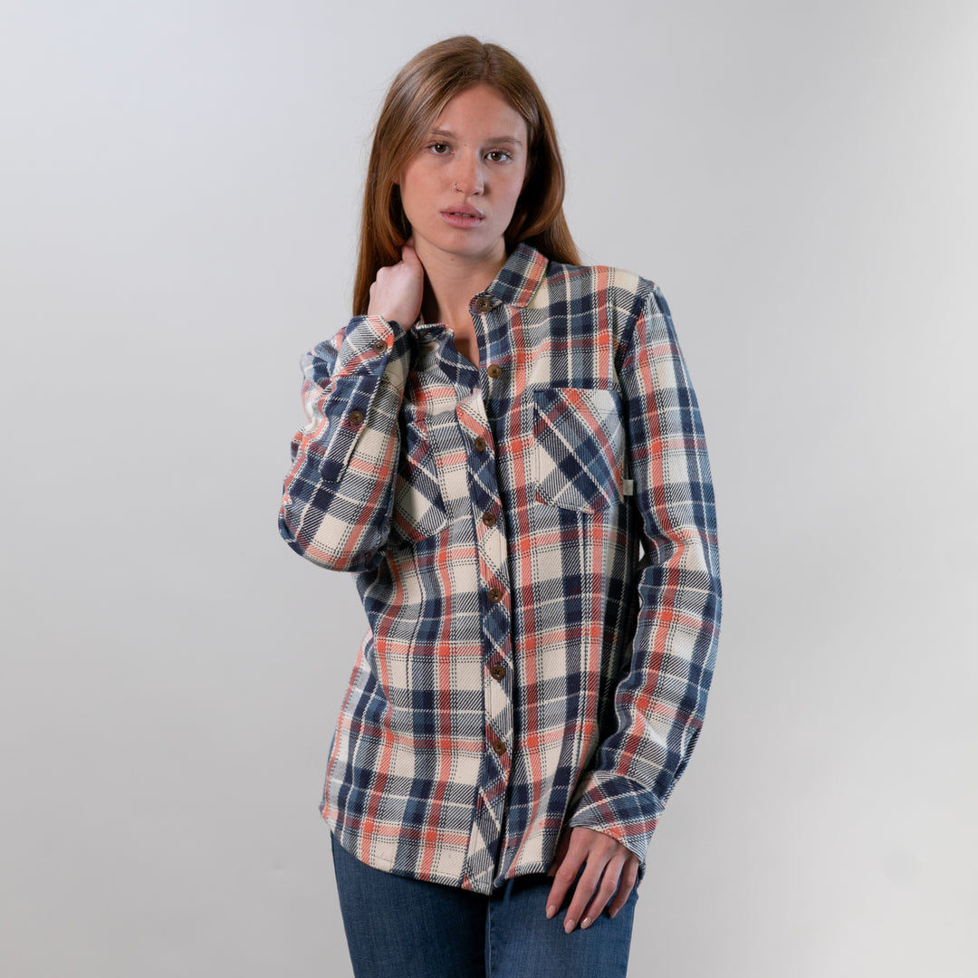 Woman wearing a plaid shirt against a plain background