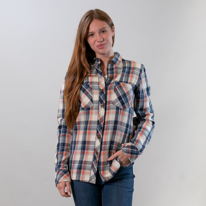 Woman wearing a plaid shirt against a plain background