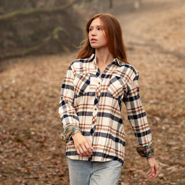A woman with long reddish hair, wearing the Women&