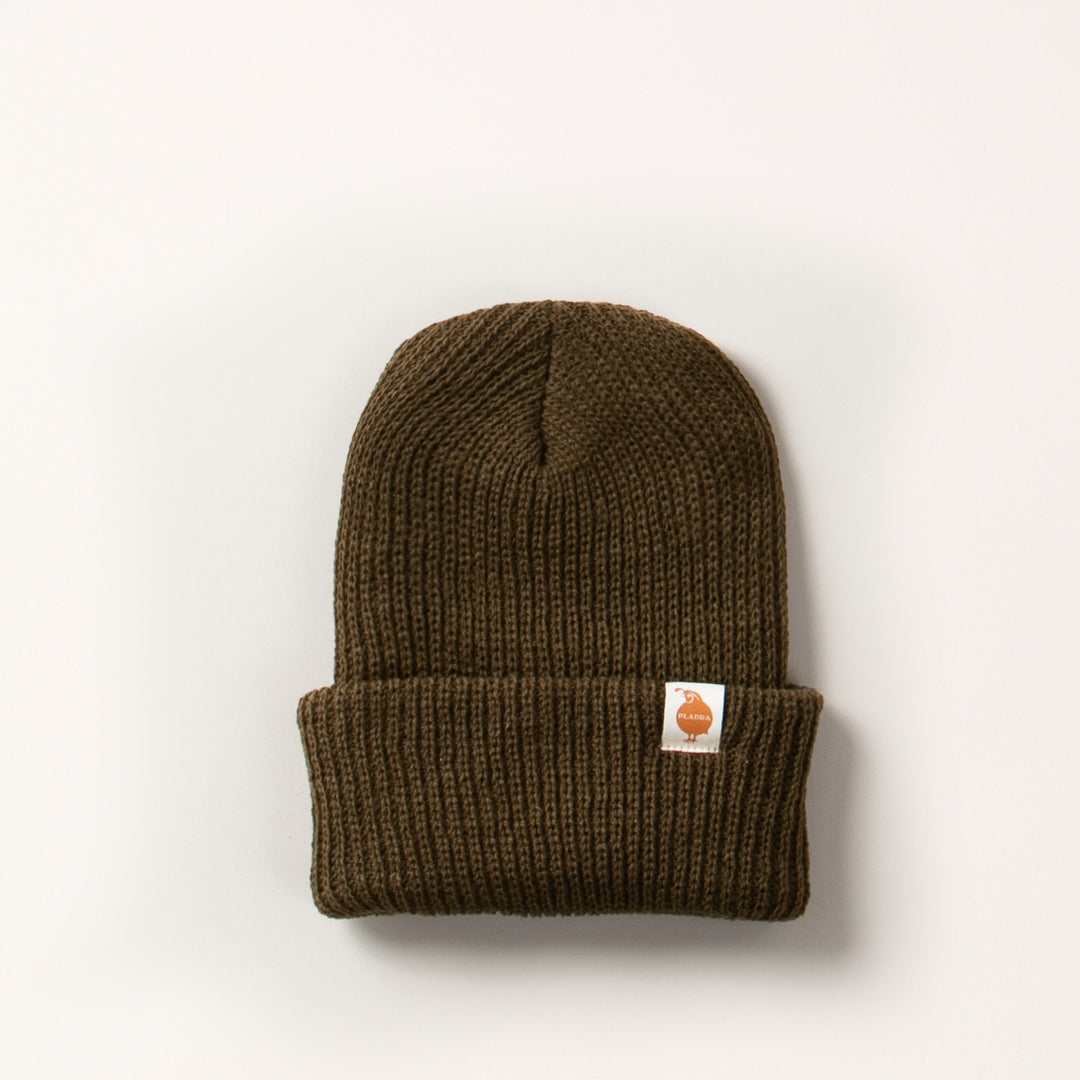 Pladra Watch Cap Beanie in olive green with folded brim, orange logo patch, made in USA, shown on white background.