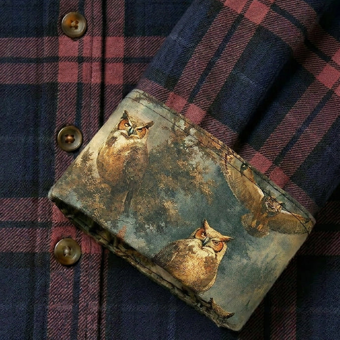 A close-up of the Women's Every Day Elite Flannel Shirt in Farallon Grey, made from premium cotton flannel with brown buttons. The folded cuff reveals a contrasting fabric adorned with playful owls and tree illustrations.