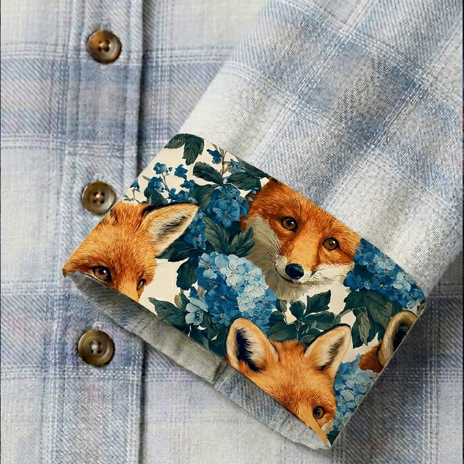 A close-up of the Women's Every Day Flannel Shirt—Snow White Heather shows its sleeve cuff turned up, revealing a fox and blue flower lining. Crafted from 100% cotton Portuguese flannel for comfort and style.