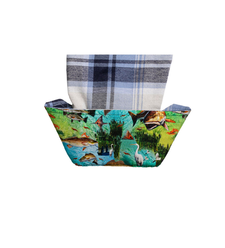 A fabric basket with a wildlife print holds a folded Pladra Women&