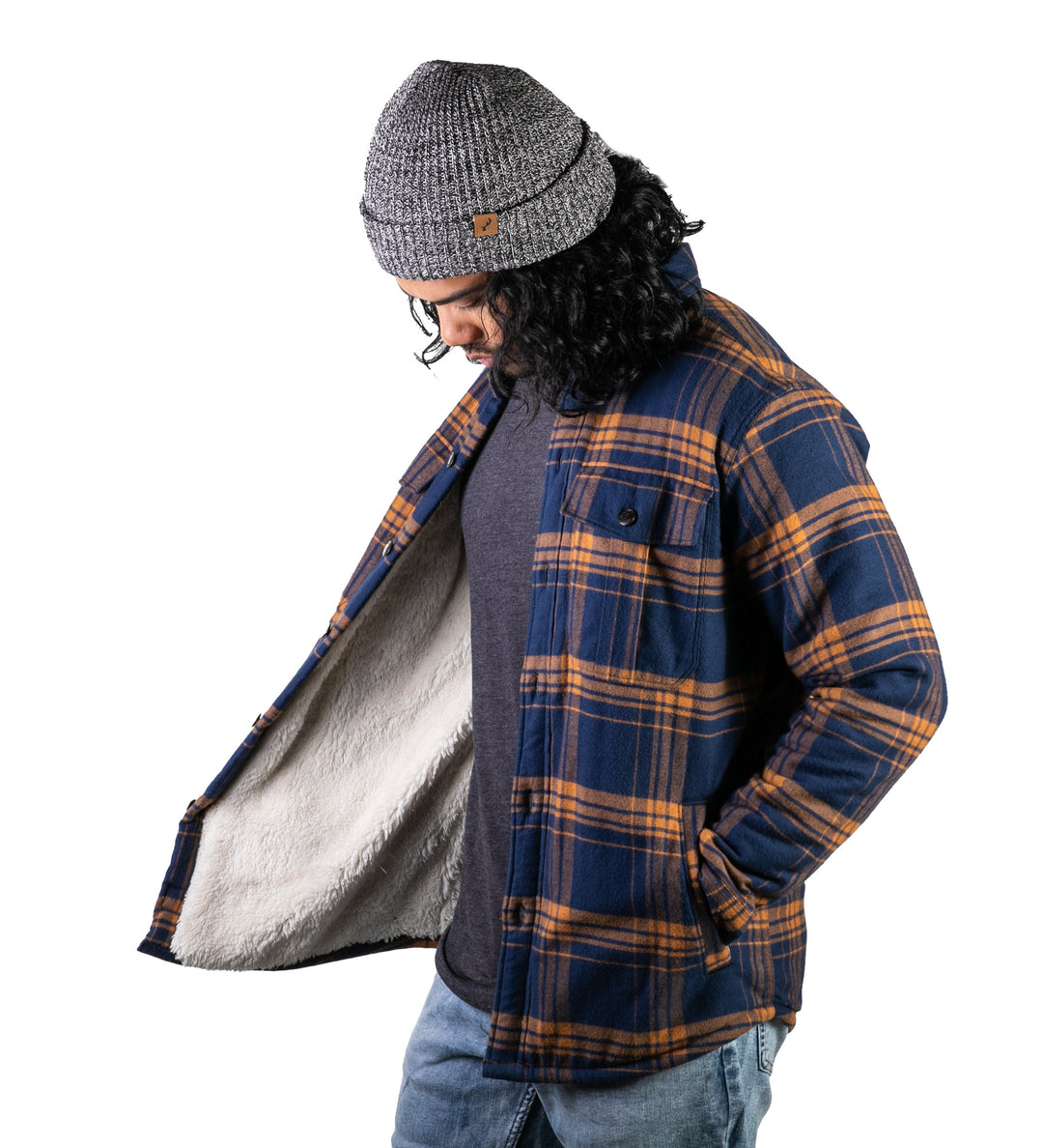 A man wearing jeans and a gray knit beanie models the Men&