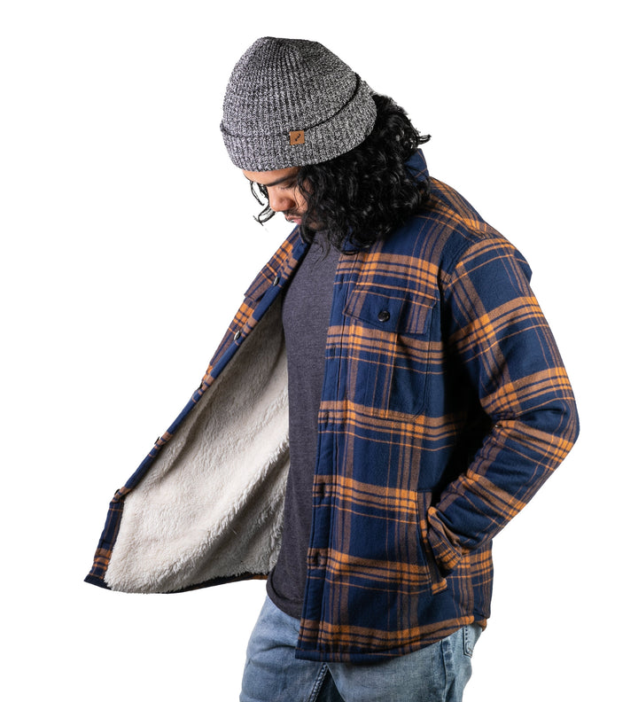 A man wearing jeans and a gray knit beanie models the Men&