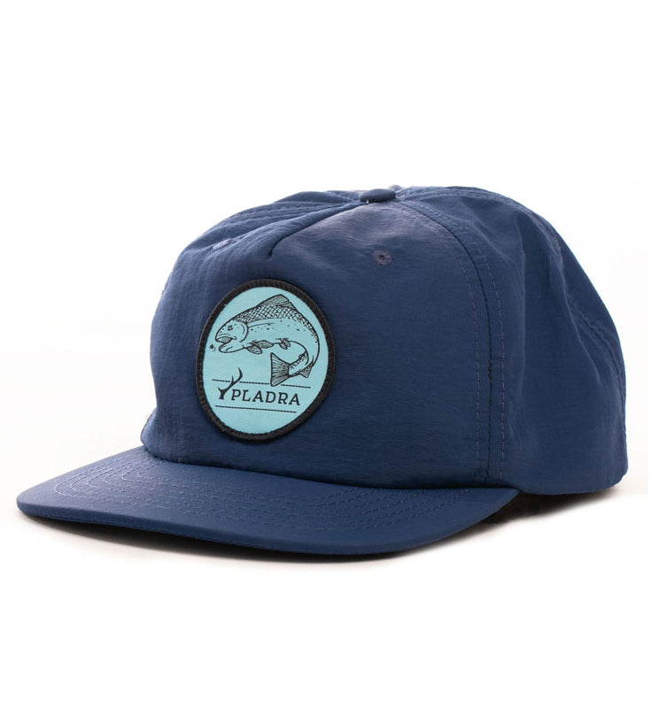 The Nylon Trout Hat- Navy Blue is a quick-drying fishing hat with a round front patch showing a fish illustration and “PLADRA” text, displayed against a white background.