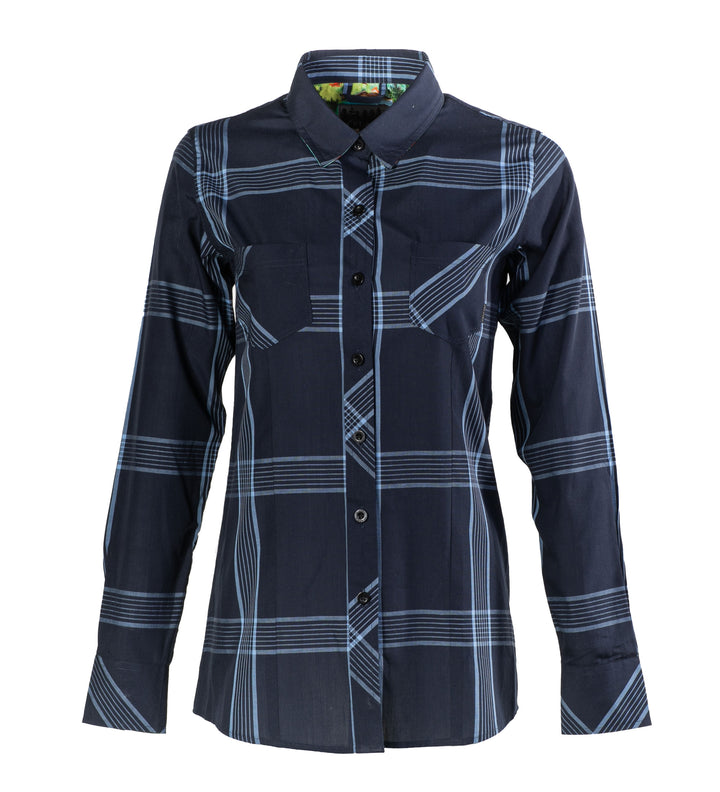 The Women’s Breeze Shirt in Ocean Blue is a long-sleeved, button-up tencel cotton shirt with a navy and light blue plaid pattern, two chest pockets, and a collar.