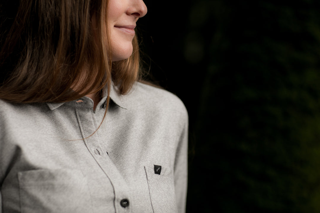 A woman with long hair smiles softly, wearing the Pladra Women&