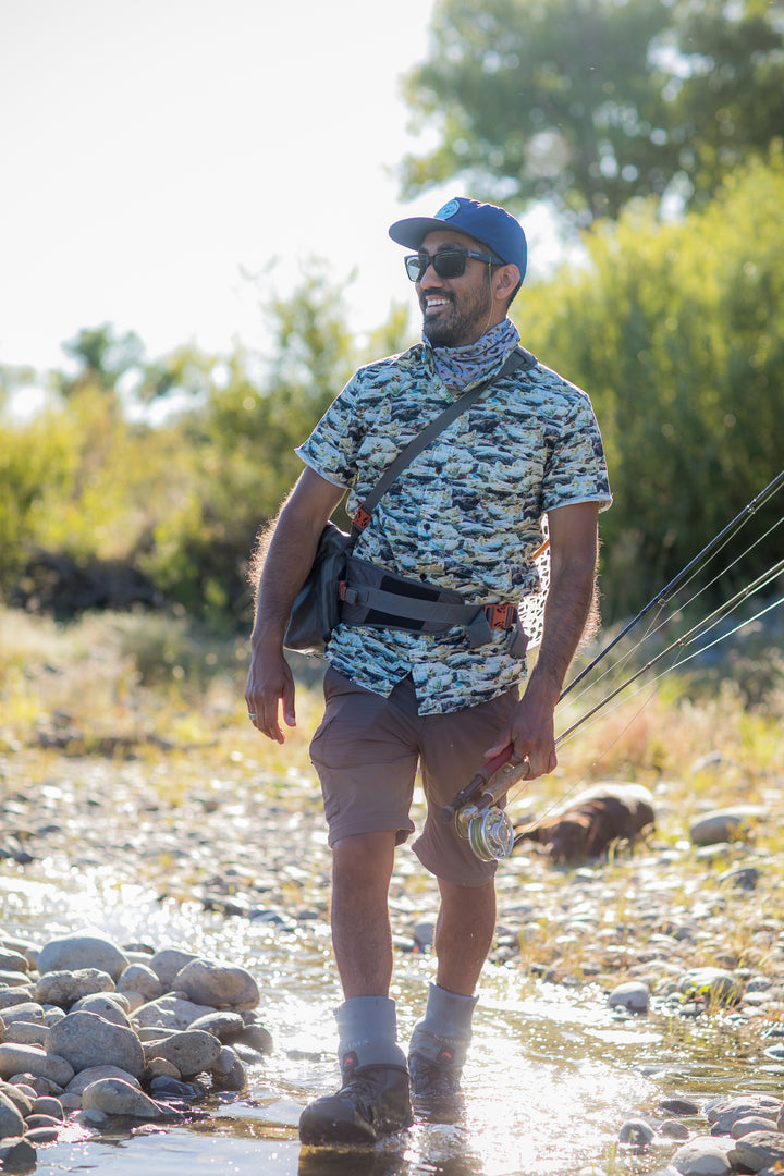 Man fishing in rocky stream, wearing Pladra Men&