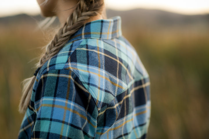 A close-up shows someone with a loose braid wearing the Women&