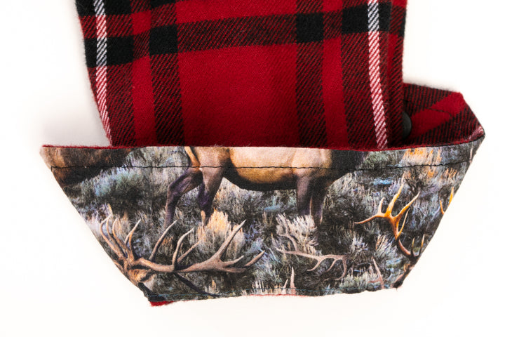 Close-up of premium cotton flannel in Rocky Red plaid from the Toddler Cubs Flannel Shirt, paired with a nature print liner featuring a deer amid foliage and antlers—perfect for a cozy, stylish look.