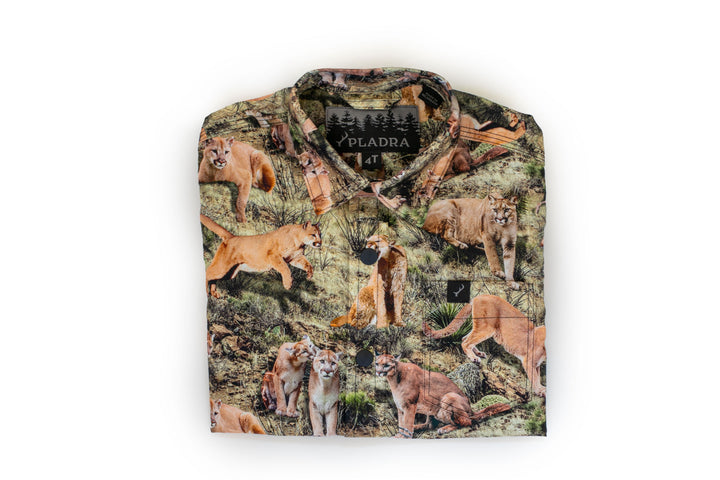 Pladra Toddler Cubs Outdoor Aloha Shirt features a mountain lion print in a grassy scene.