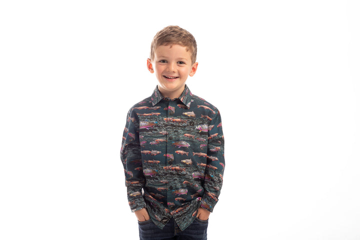 Smiling boy wears Pladra Toddler Cubs Printed Shirt-Trout, standing with hands in pockets against a white background.