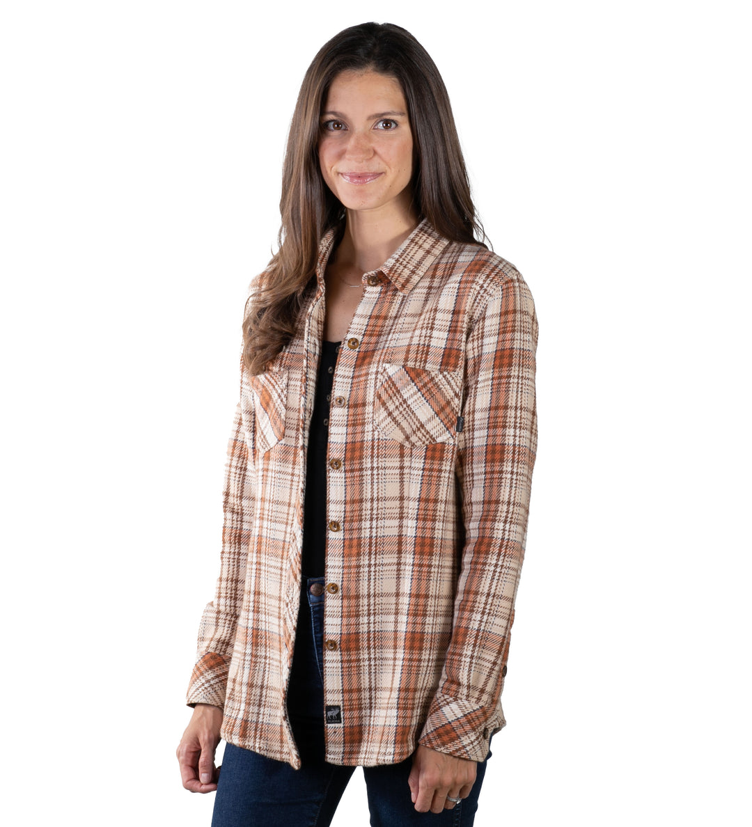 A woman with long brown hair smiles at the camera, wearing the Women&