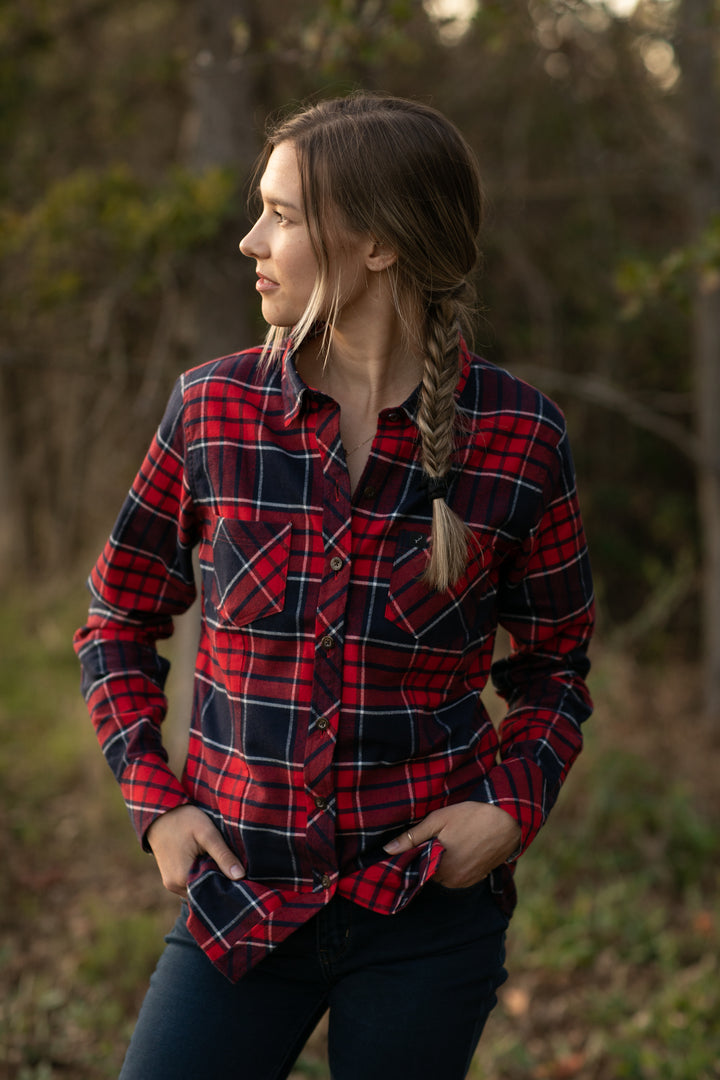 A woman with a fishtail braid stands outdoors in a Women&