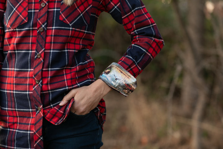 A woman stands outdoors in a Women&